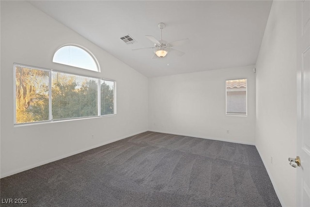 carpeted spare room featuring lofted ceiling and ceiling fan