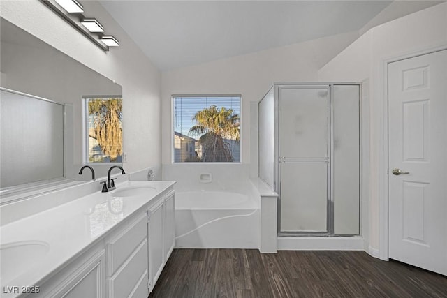 bathroom featuring separate shower and tub, hardwood / wood-style floors, lofted ceiling, and vanity