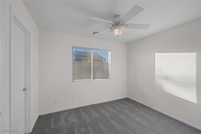 carpeted spare room featuring ceiling fan