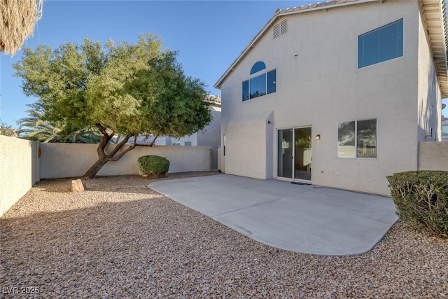 back of house with a patio area