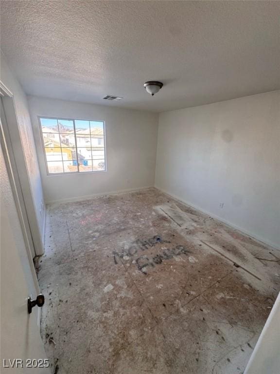 empty room with a textured ceiling