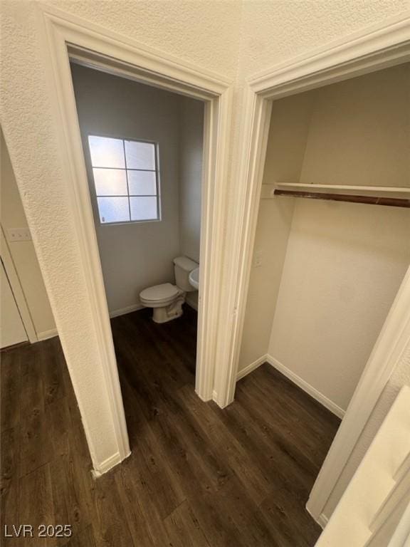 interior space featuring toilet and hardwood / wood-style flooring