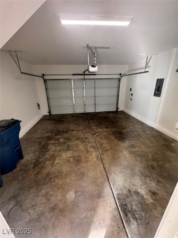 garage with a garage door opener and electric panel