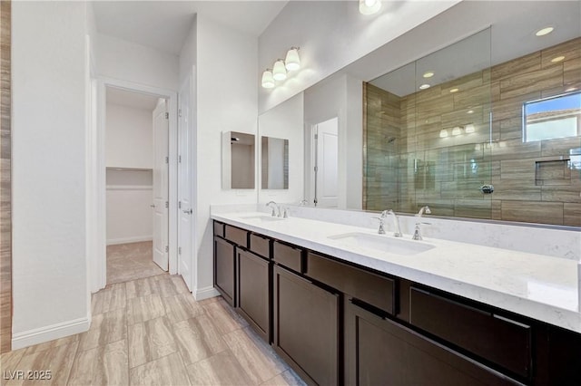 bathroom with a shower with door and vanity