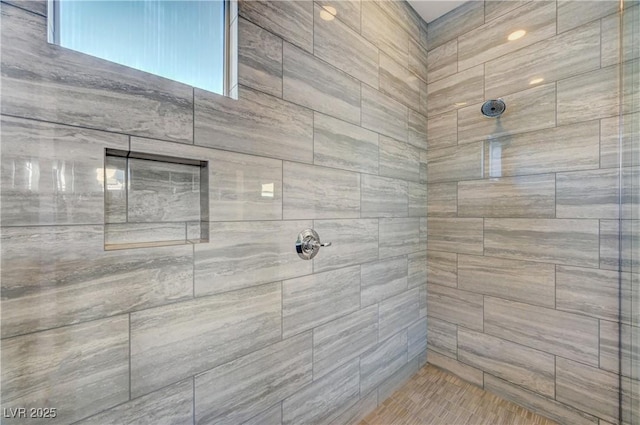 bathroom with a tile shower