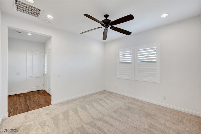 carpeted spare room featuring ceiling fan