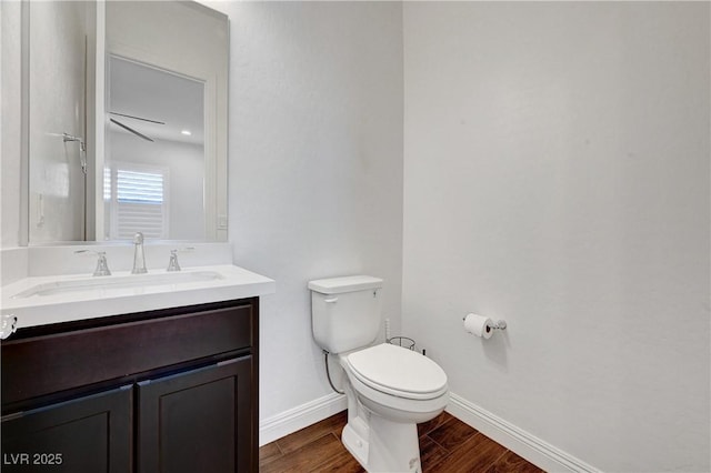 bathroom featuring hardwood / wood-style flooring, toilet, and vanity