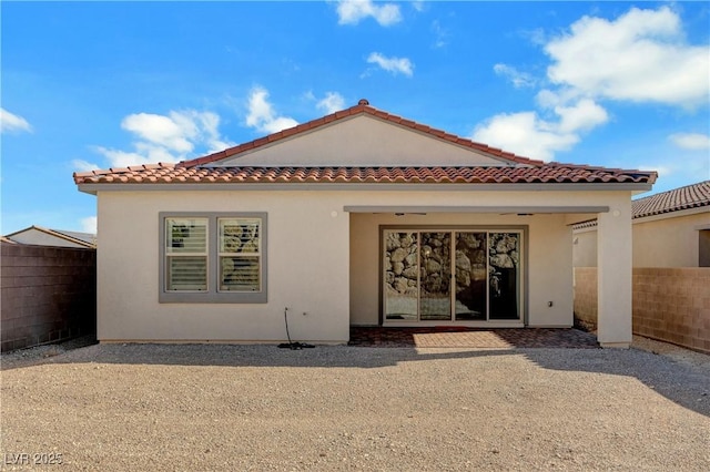 back of property with a patio