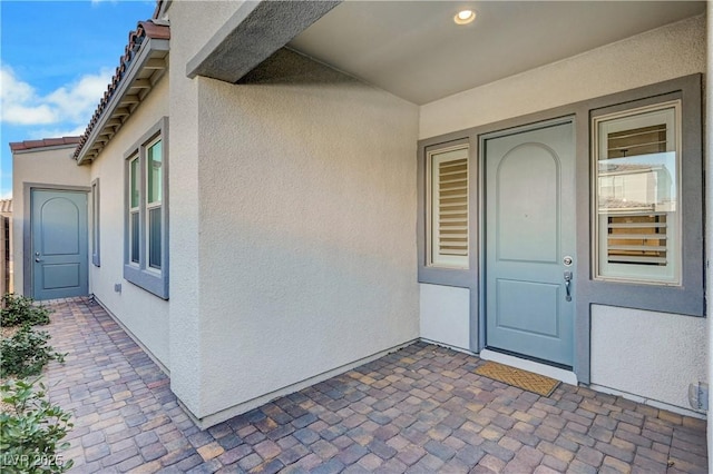 entrance to property with a patio area