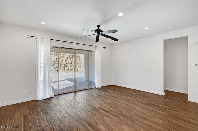 empty room featuring ceiling fan and dark wood-type flooring