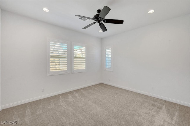 empty room featuring light carpet and ceiling fan