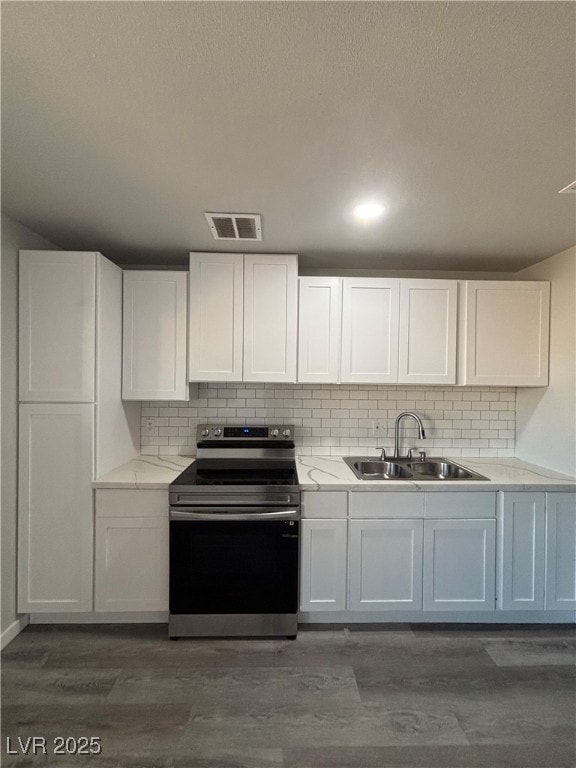 kitchen featuring sink, dark hardwood / wood-style flooring, white cabinets, and electric stove