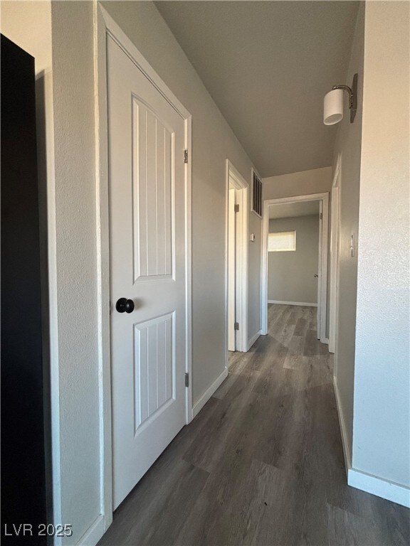 hall with dark hardwood / wood-style flooring