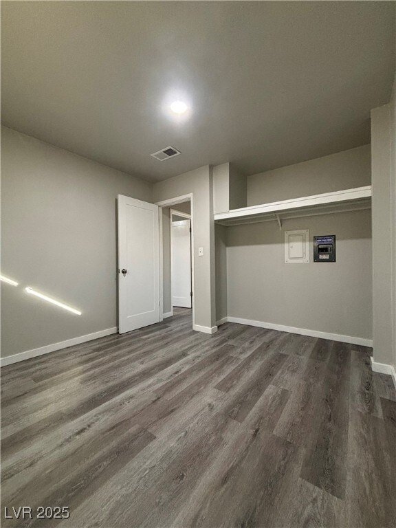 laundry area with dark wood-type flooring