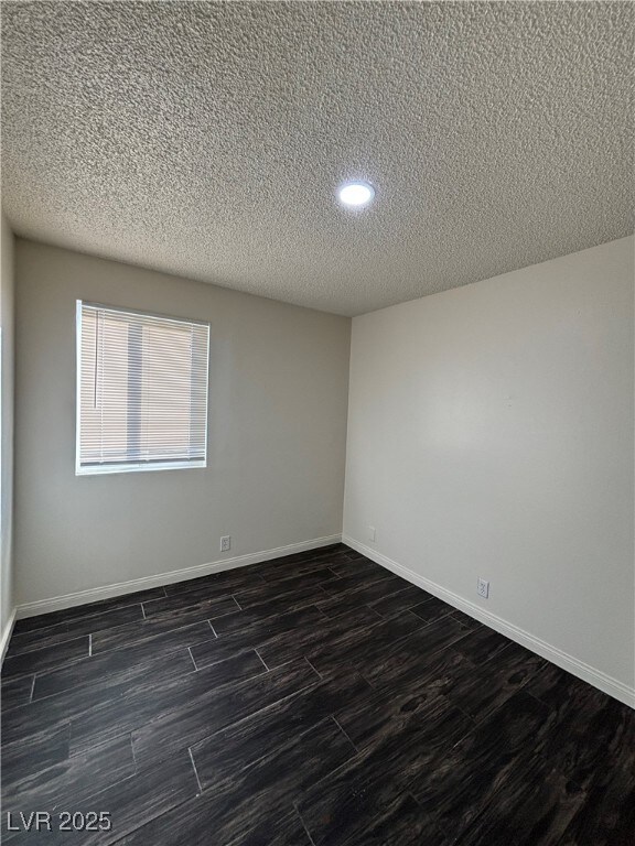 unfurnished room featuring a textured ceiling