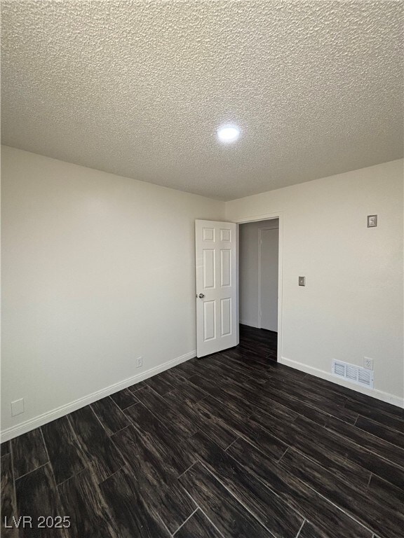 empty room with a textured ceiling