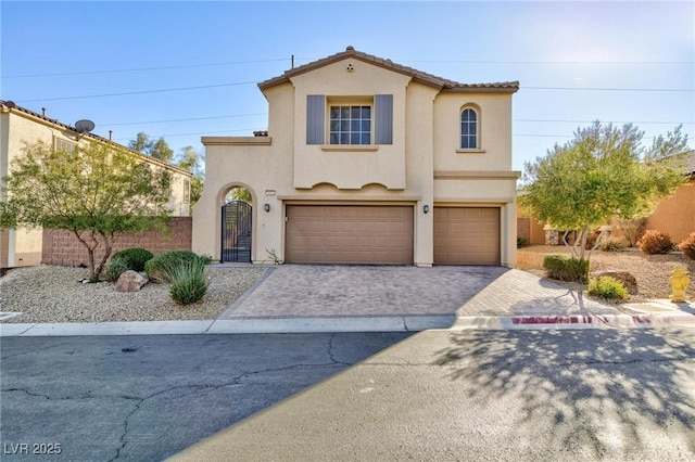 mediterranean / spanish-style home with a garage