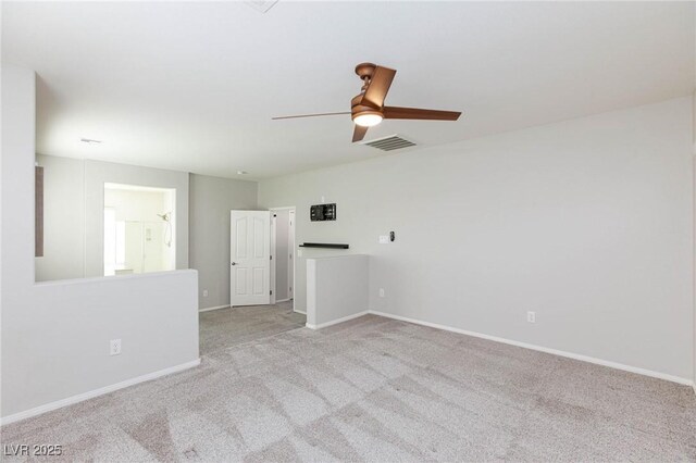 carpeted spare room with ceiling fan