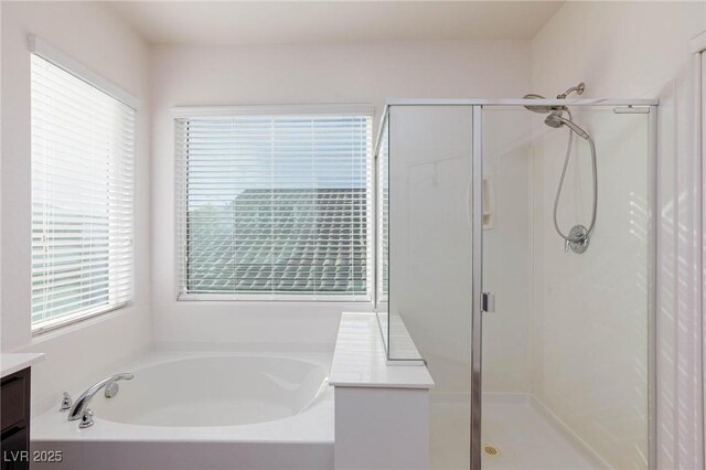 bathroom featuring independent shower and bath and vanity