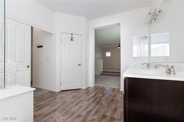 bathroom featuring hardwood / wood-style flooring, ceiling fan, and vanity