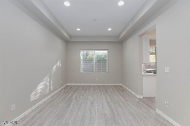 unfurnished room with light hardwood / wood-style floors