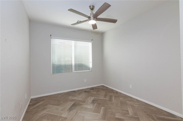 spare room with ceiling fan and parquet flooring