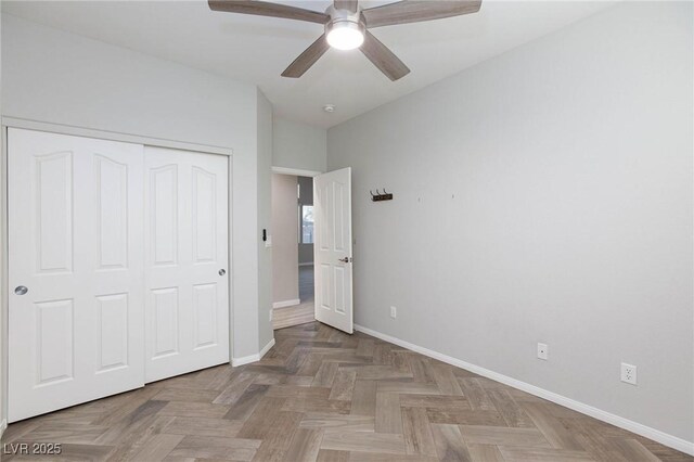 unfurnished bedroom featuring a closet, ceiling fan, and parquet floors