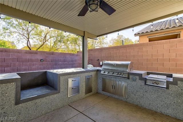 view of patio / terrace featuring exterior kitchen, grilling area, and ceiling fan