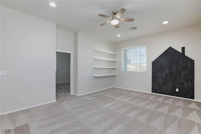 unfurnished living room featuring ceiling fan and light carpet