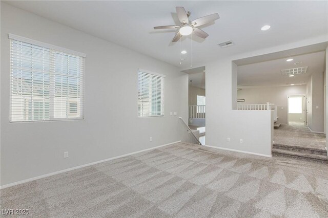 unfurnished room with ceiling fan and light carpet