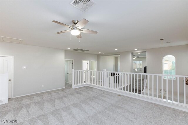 unfurnished room with ceiling fan and light colored carpet