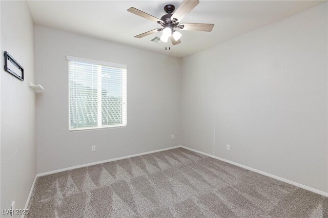 carpeted spare room with ceiling fan