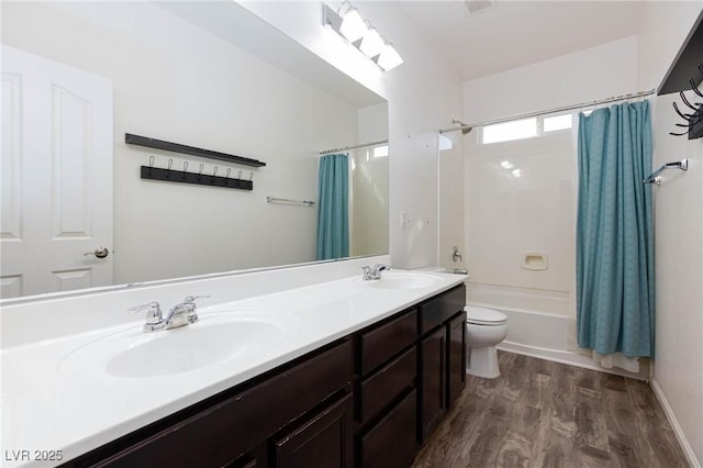 full bathroom featuring toilet, hardwood / wood-style flooring, shower / bath combination with curtain, and vanity