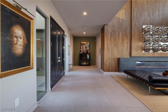 hallway featuring wood walls