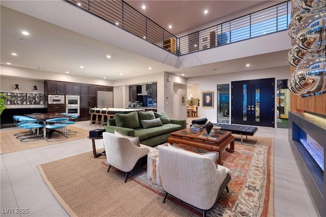 living room featuring a high ceiling and light tile patterned flooring