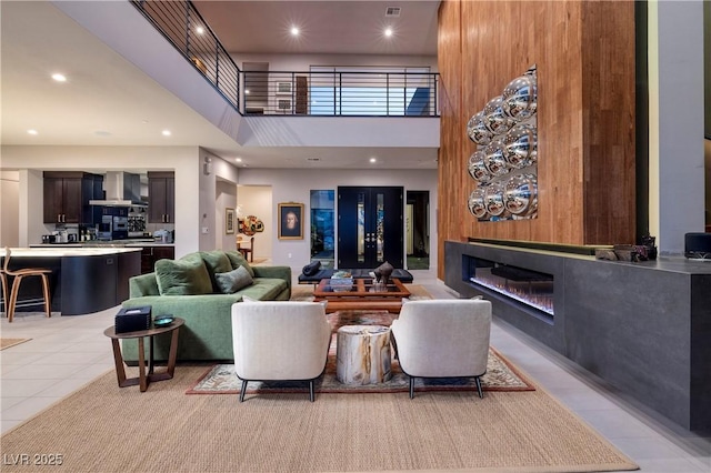 tiled living room with a high ceiling