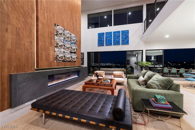 living room with a high ceiling and tile patterned floors