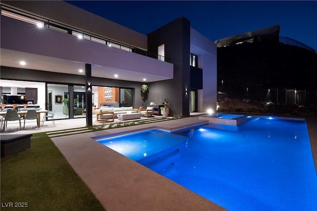 view of pool featuring an in ground hot tub, a patio area, and an outdoor living space