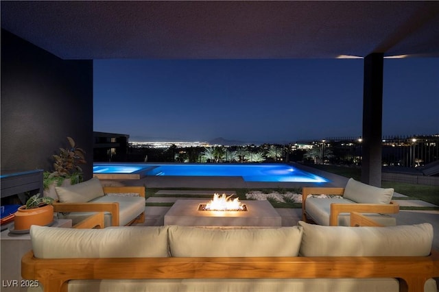 exterior space featuring an outdoor living space with a fire pit