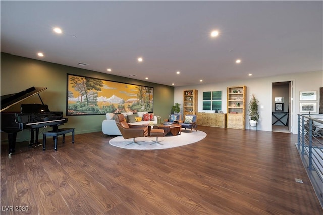 living room featuring built in shelves and dark hardwood / wood-style floors