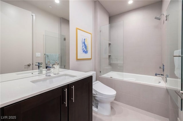 full bathroom with toilet, vanity, and tiled shower / bath