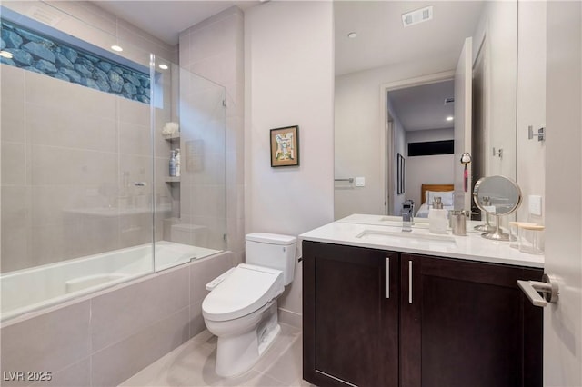 full bathroom with shower / bath combination with glass door, tile patterned flooring, toilet, and vanity