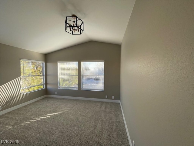 unfurnished room featuring vaulted ceiling and carpet flooring