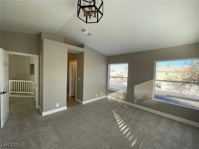 interior space with lofted ceiling, carpet flooring, and a chandelier