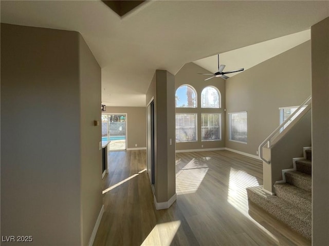 entrance foyer featuring lofted ceiling, ceiling fan, and dark wood-type flooring