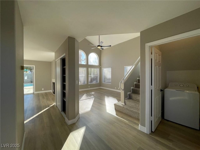 foyer entrance with hardwood / wood-style floors, ceiling fan, washer / dryer, and vaulted ceiling