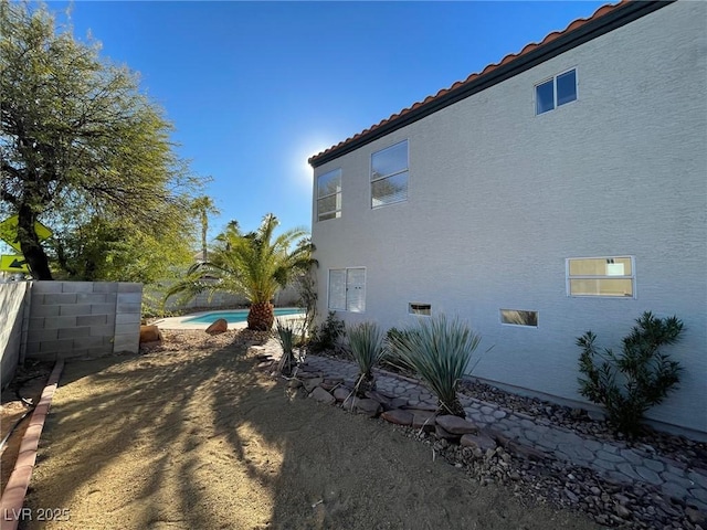 view of home's exterior featuring a fenced in pool