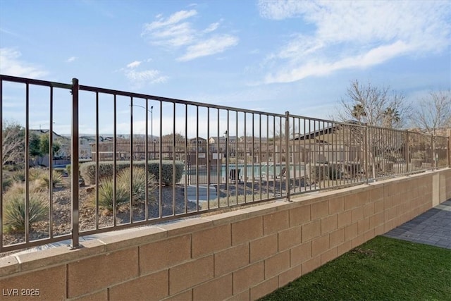 exterior space with fence and a pool