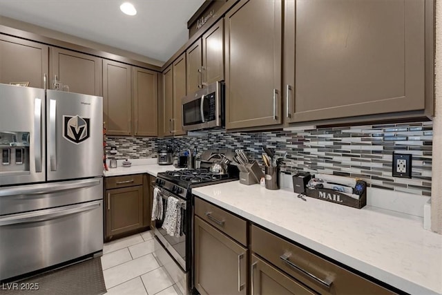 kitchen featuring stainless steel appliances, recessed lighting, light tile patterned floors, and tasteful backsplash