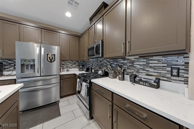 kitchen with light tile patterned floors, visible vents, decorative backsplash, appliances with stainless steel finishes, and recessed lighting